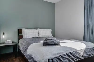 a bedroom with a bed with two towels on it at Edmonton House w/5BR/3BA/2Kitchens & Fenced Yard in Edmonton
