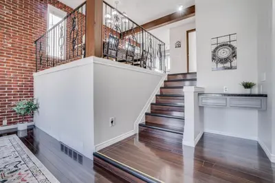 a staircase in a home with a brick wall at Edmonton House w/5BR/3BA/2Kitchens & Fenced Yard in Edmonton