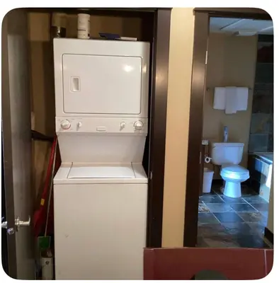 a small kitchen with a refrigerator and a toilet at Canmore Mountain View in Canmore