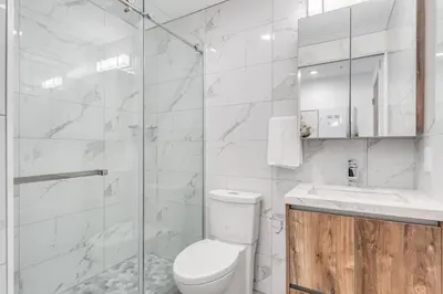 a white bathroom with a toilet and a shower at Modern Studio Condo in Central Prime Location in Vancouver
