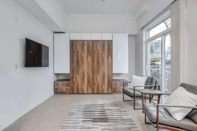 a living room with a couch and a table at Modern Studio Condo in Central Prime Location in Vancouver