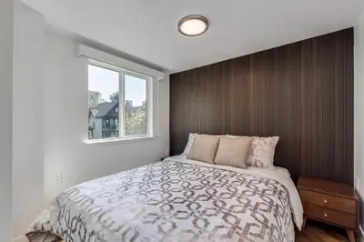 a bedroom with a large bed and a window at Luxury 2BR Walk to Everything Downtown in Vancouver