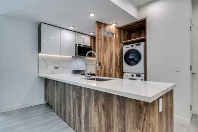 a kitchen with a sink and a dishwasher at Luxury 2BR Walk to Everything Downtown in Vancouver
