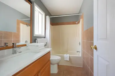 a bathroom with a sink and a toilet and a tub at Park Motel in Hope