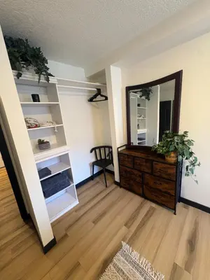 a living room with a mirror and a dresser at Charming Mission Downtown Condo in Calgary