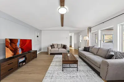 a living room with a couch and a tv at Affordable & Cozy 3-bedroom, Minutes to City Core in Calgary