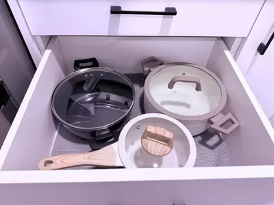 a small white box with a toilet and a pan at Cozy Haven 2 in Bélanger