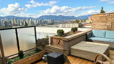 a balcony with a view of a city at City Line Views w Rooftop Patio in Vancouver