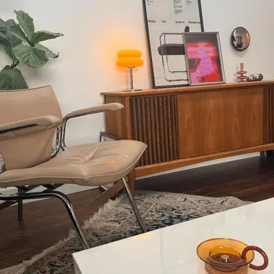 a chair in a living room with a table at City Line Views w Rooftop Patio in Vancouver
