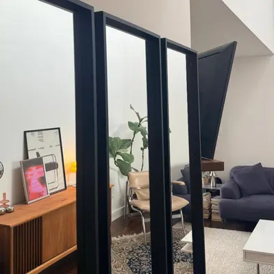 a living room with two glass doors and a blue couch at City Line Views w Rooftop Patio in Vancouver