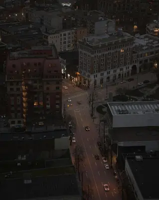 a city street at night with cars on the road at City Line Views w Rooftop Patio in Vancouver