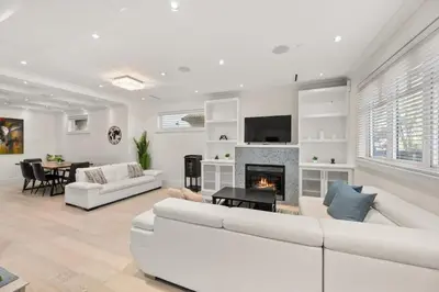 a living room with a white couch and a fireplace at Your Next Stay Spacious Bright & Sophisticated in Vancouver