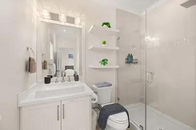 a white bathroom with a toilet and a shower at Your Next Stay Spacious Bright & Sophisticated in Vancouver