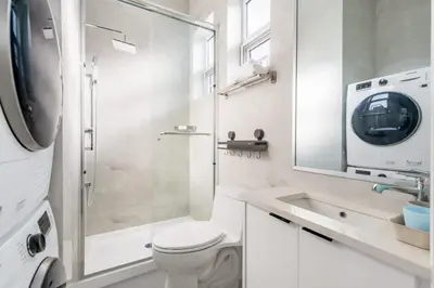 a bathroom with a shower and a toilet and a sink at Modern Vancouver Private Room-15 Mins to Downtown in Vancouver