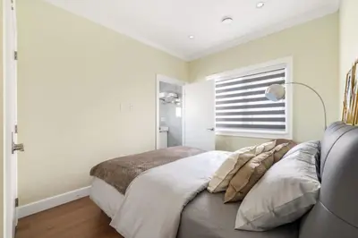 a bedroom with a large bed and a window at Modern Vancouver Private Room-15 Mins to Downtown in Vancouver