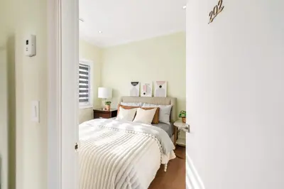 a bedroom with a bed with a striped blanket at Modern Vancouver Private Room-15 Mins to Downtown in Vancouver