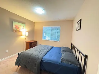 a bedroom with a bed and a window in it at Surrey-Delta Urban Stay - Walk to Transit & Shopping in Surrey