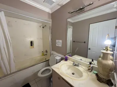 a bathroom with a sink and a toilet and a mirror at Surrey-Delta Urban Stay - Walk to Transit & Shopping in Surrey