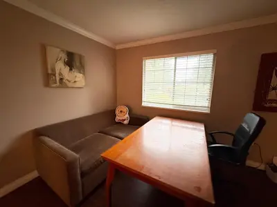 a living room with a couch and a table at Surrey-Delta Urban Stay - Walk to Transit & Shopping in Surrey