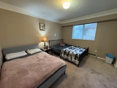 a bedroom with two beds and a window at Nordel Way Guest House - Walk to Transit & Shopping - 20 Min to YVR in Surrey