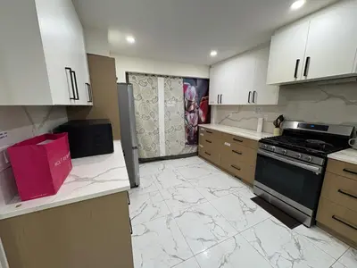 a kitchen with white cabinets and marble counter tops at Downtown Vancouver Cozy Room - Near SkyTrain, BC Place & Free Parking in Vancouver