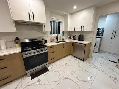 a kitchen with white cabinets and a stove top oven at Downtown Vancouver Cozy Room - Near SkyTrain, BC Place & Free Parking in Vancouver