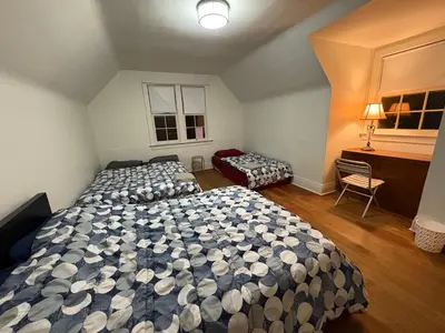 a bedroom with two beds and a desk at Vancouver Large Room for 5 - Near YVR Airport, Transit & Free Parking in Vancouver