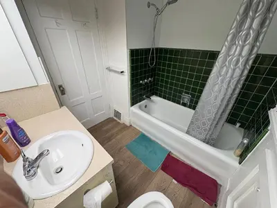 a bathroom with a sink and a toilet and a tub at Vancouver Large Room for 5 - Near YVR Airport, Transit & Free Parking in Vancouver