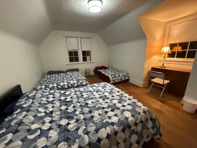 a bedroom with two beds and a desk in it at Vancouver Large Room for 5 - Near YVR Airport, Transit & Free Parking in Vancouver