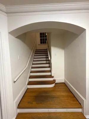 a staircase in a house with white walls and wooden floors at Vancouver Large Room for 5 - Near YVR Airport, Transit & Free Parking in Vancouver