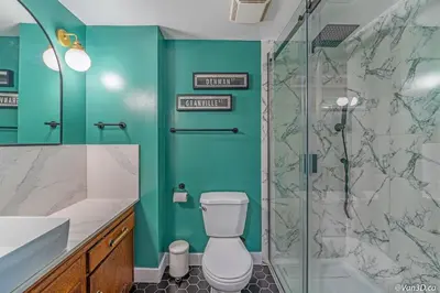 a bathroom with a toilet and a glass shower at Beautiful Downtown Studio with Parking in Vancouver