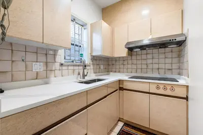 a kitchen with wooden cabinets and a sink at Cozy & Modern Room near Langara & Downtown in Vancouver