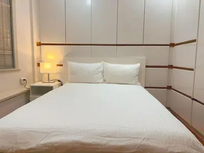 a bedroom with a large white bed with two pillows at Cozy & Modern Room near Langara & Downtown in Vancouver