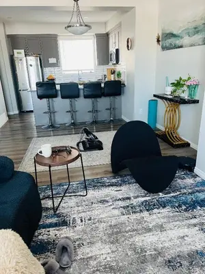 a living room with a couch and a table at Spacious Private Room with TV, WiFi and Fridge in Edmonton