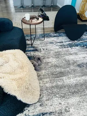a living room with a white rug and a table at Spacious Private Room with TV, WiFi and Fridge in Edmonton