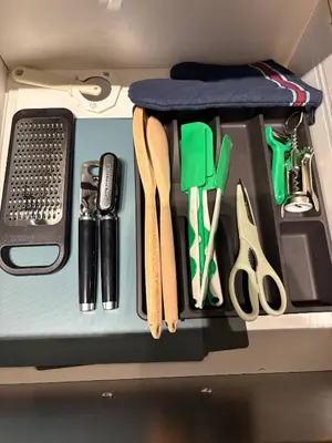 a drawer with utensils and other items on it at Royal Bay Guest Suite in Victoria
