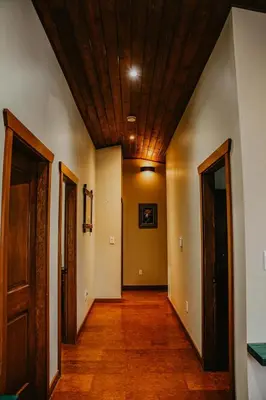 an empty hallway with a wooden ceiling and doors at Big Bear Chalet and spa in Revelstoke