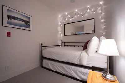 a bedroom with a bed with lights on the wall at Tu Casa - 2 Bedroom Condo with Private Hot tub in Revelstoke