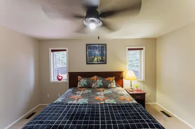 a bedroom with a bed and a ceiling fan at Bright 3BR Upper Suit, 23 min to Jasper NP in Hinton