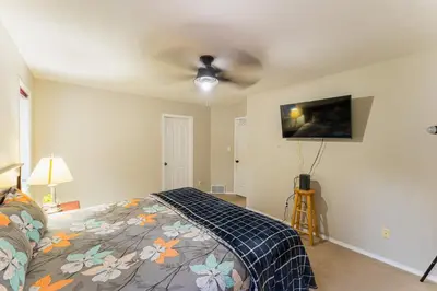 a bedroom with a bed and a ceiling fan at Bright 3BR Upper Suit, 23 min to Jasper NP in Hinton