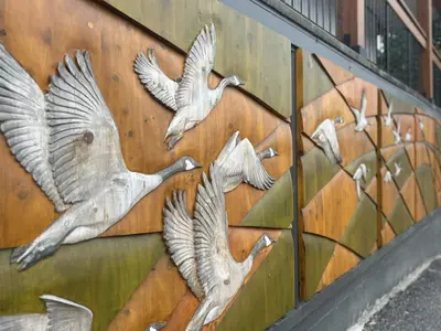 a wall with three birds painted on it at Chalet Inn in Kitimat