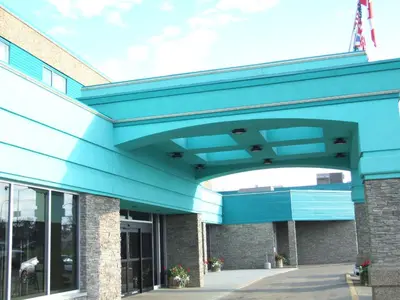 a view of a building with a blue roof at Lakeland Inn Hotel in Cold Lake