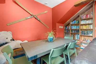 a dining room with a table and some bookshelves at Squamish Adventure Inn in Squamish