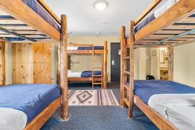 a room with three bunk beds in a cabin at Squamish Adventure Inn in Squamish