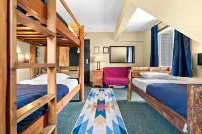 a room with two bunk beds and a mirror at Squamish Adventure Inn in Squamish