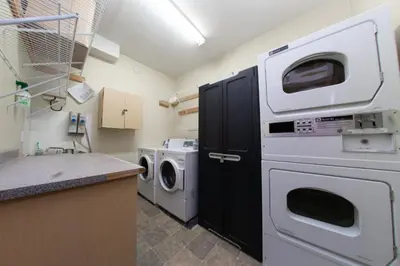 a laundry room with a washer and dryer at Squamish Adventure Inn in Squamish