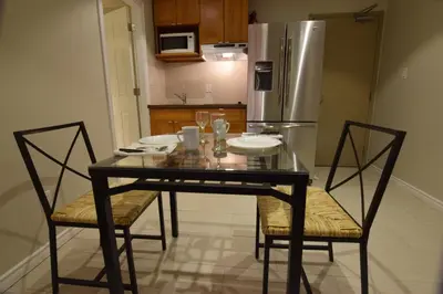 a kitchen with a table and chairs and a refrigerator at The Lion Inn & Suites in Chetwynd