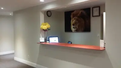 a room with a picture of a lion on the wall at The Lion Inn & Suites in Chetwynd
