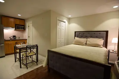 a bedroom with a bed and a table and a kitchen at The Lion Inn & Suites in Chetwynd