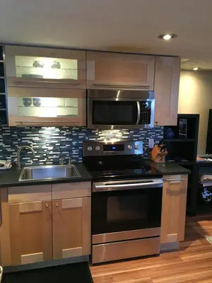 a kitchen with a stove and a sink and a microwave at The White Brick Inn in Jasper